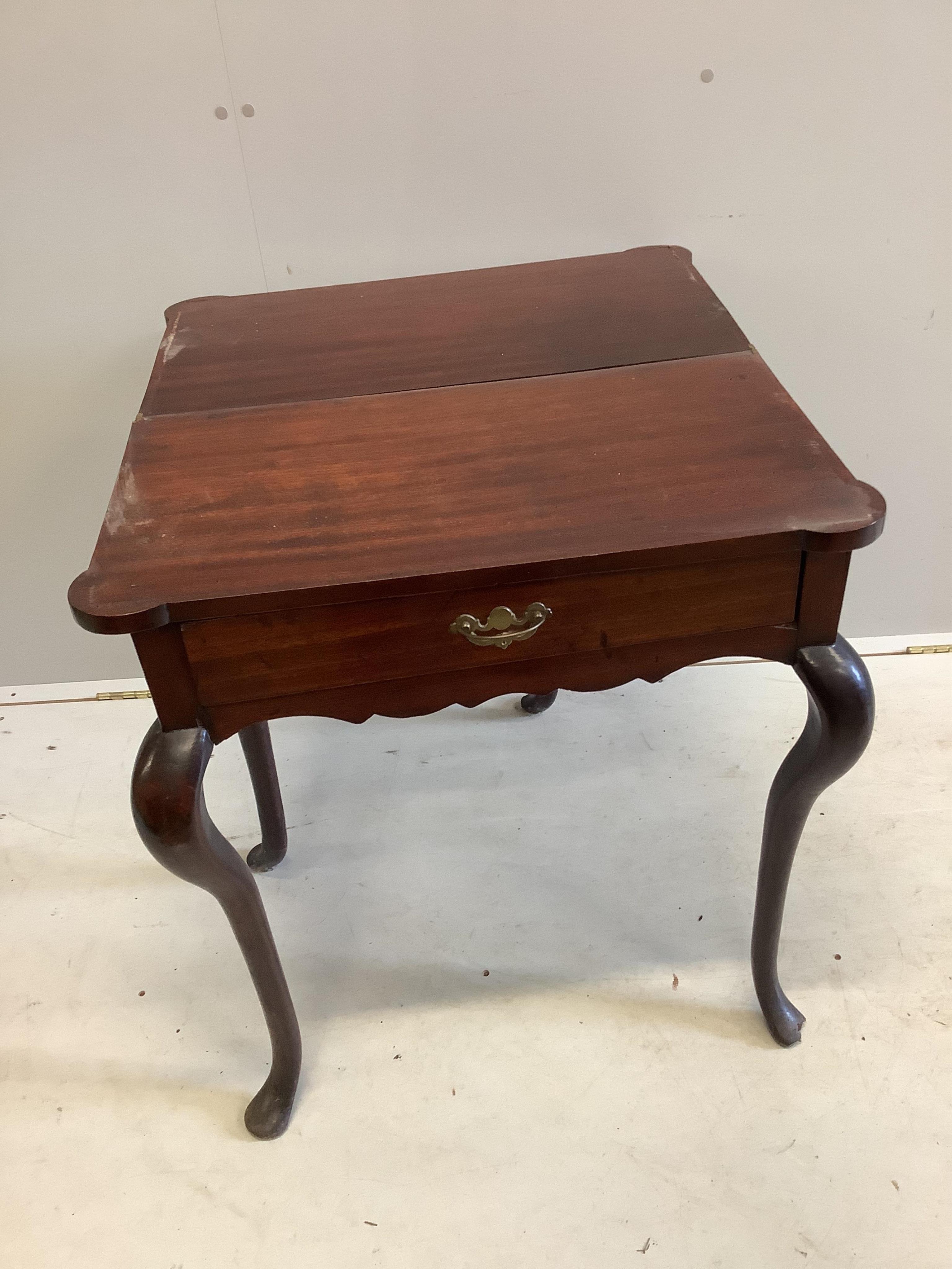 A George III mahogany folding tea table, on cabriole legs, width 67cm, depth 37cm, height 72cm. Condition - poor to fair